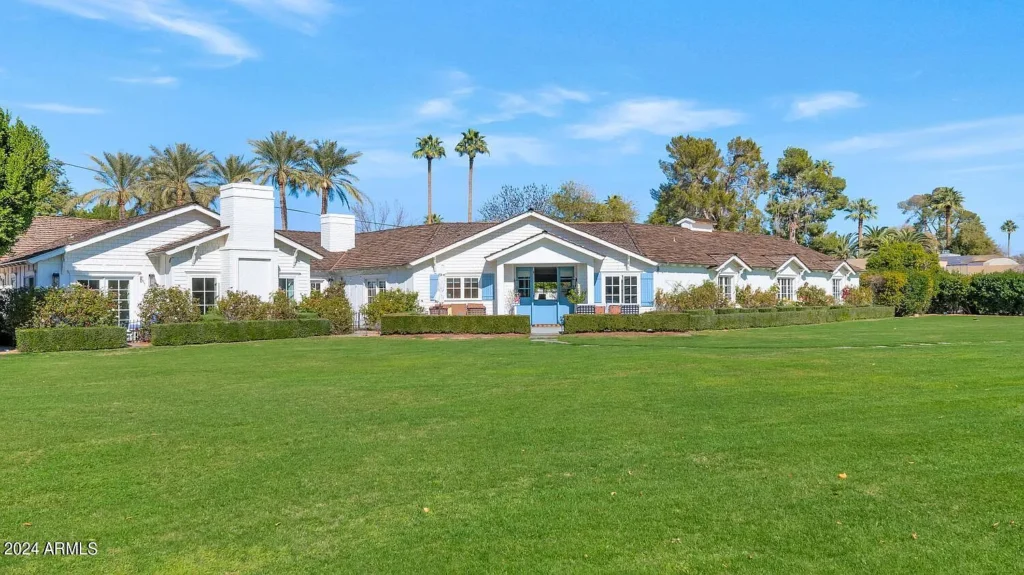Arcadia Classic Ranch exterior with white siding, blue entry doors and a broad front lawn