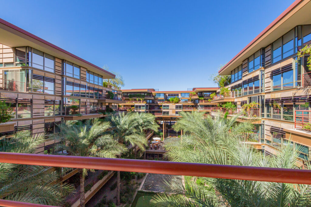 View from the balcony over palm trees to the courtyard and surrounding residence buildings